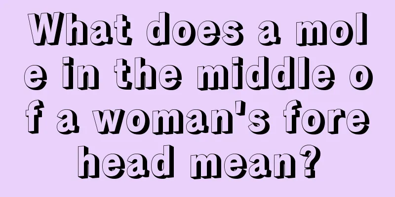What does a mole in the middle of a woman's forehead mean?
