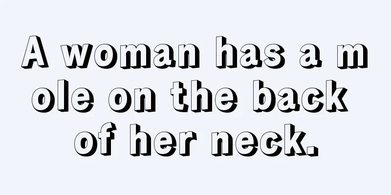 A woman has a mole on the back of her neck.