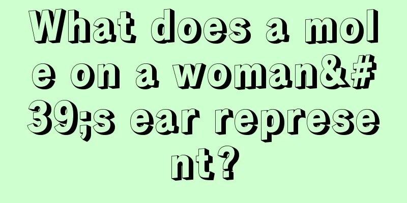 What does a mole on a woman's ear represent?