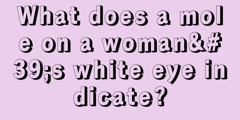 What does a mole on a woman's white eye indicate?