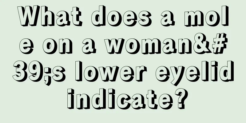 What does a mole on a woman's lower eyelid indicate?