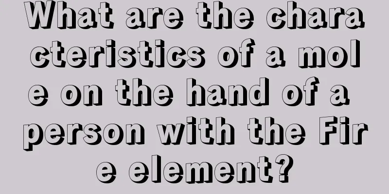 What are the characteristics of a mole on the hand of a person with the Fire element?