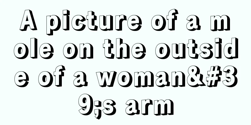 A picture of a mole on the outside of a woman's arm