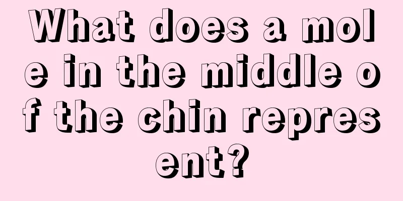 What does a mole in the middle of the chin represent?