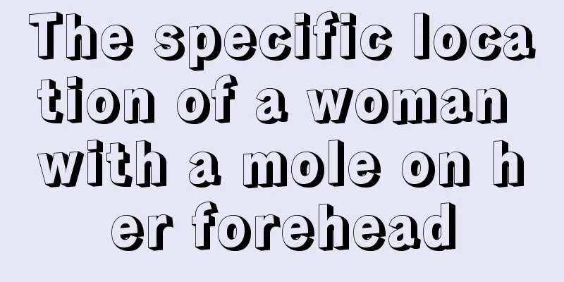 The specific location of a woman with a mole on her forehead