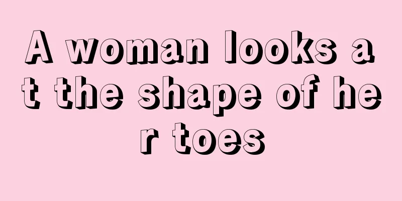 A woman looks at the shape of her toes