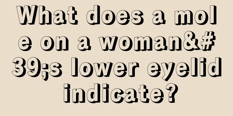 What does a mole on a woman's lower eyelid indicate?