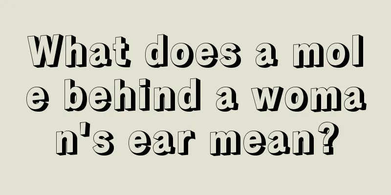 What does a mole behind a woman's ear mean?