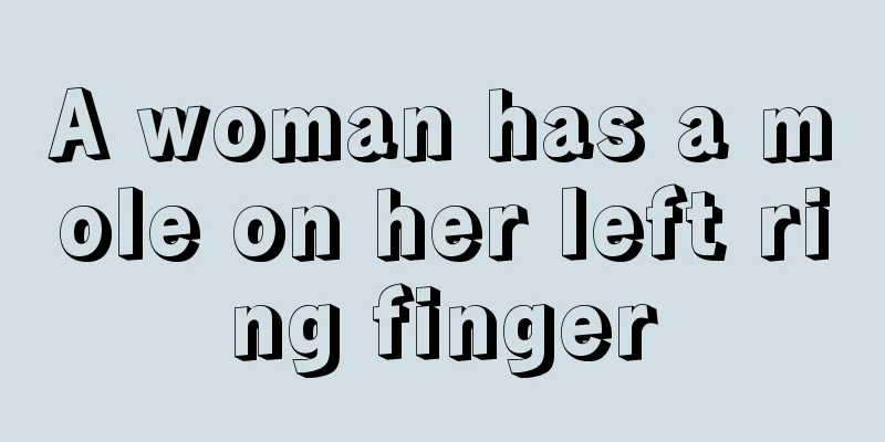 A woman has a mole on her left ring finger