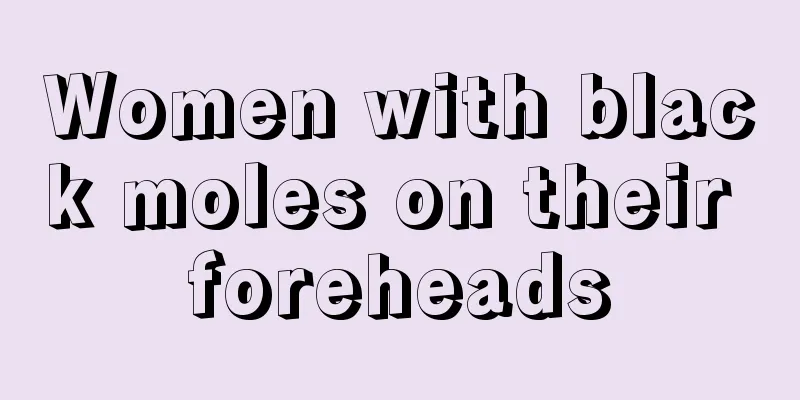 Women with black moles on their foreheads