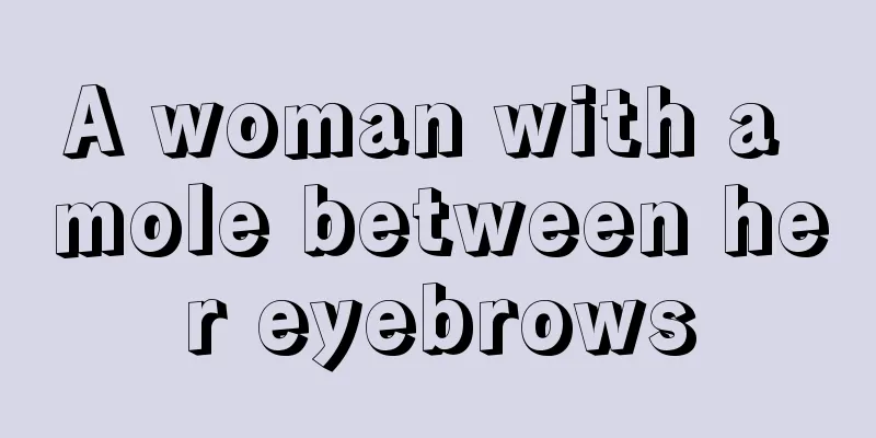 A woman with a mole between her eyebrows